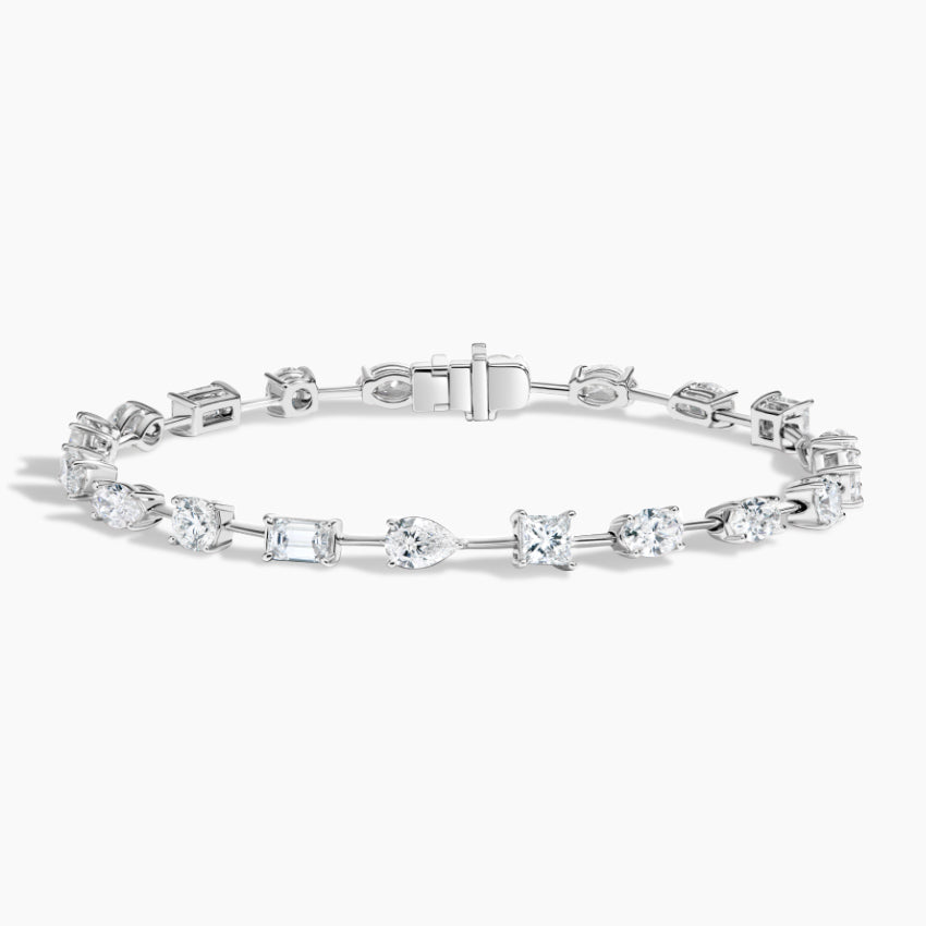 White gold tennis bracelet with assorted lab-grown diamond cuts on white background