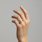 My Store 4 18K solid gold trilogy ring featuring a marquise-cut lab-grown diamond on a hand against a grey background.