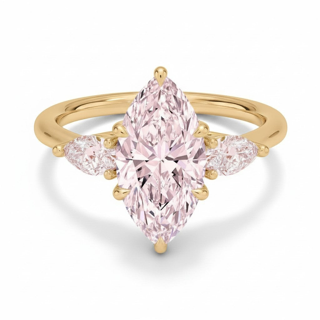 My Store 4 18K solid gold three-stone ring featuring a pear-cut lab-grown diamond with two smaller side diamonds.