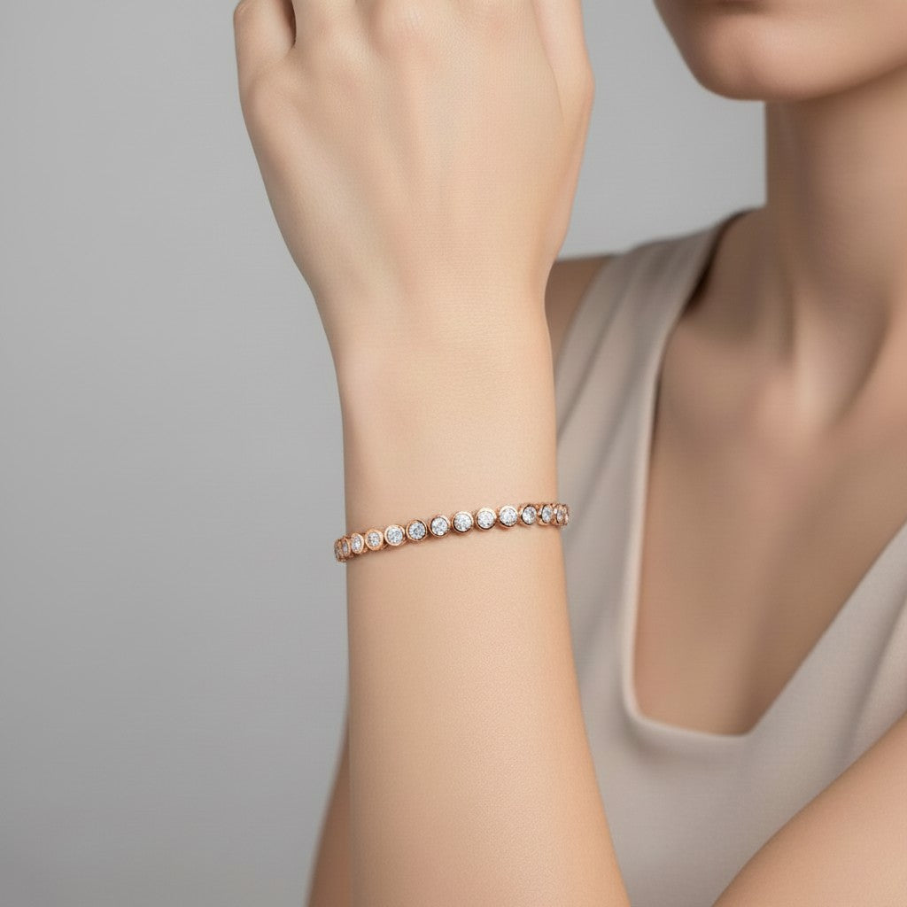 My Store 4 modern bezel round diamond line bracelet in rose gold worn on a woman's wrist