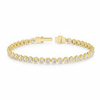 My Store 4 modern bezel diamond tennis bracelet in 14K yellow gold with round brilliant stones and secure box clasp.