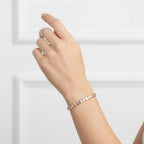 My Store 4 bezel set round diamond tennis bracelet in rose gold worn on a woman's wrist