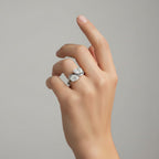 My Store 4 bypass engagement ring with two pear-cut diamonds on a fluid S-curve white gold band worn on a finger