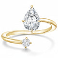 My Store 4 bypass engagement ring in 18k yellow gold with a pear-cut focal diamond and a round-cut accent stone.