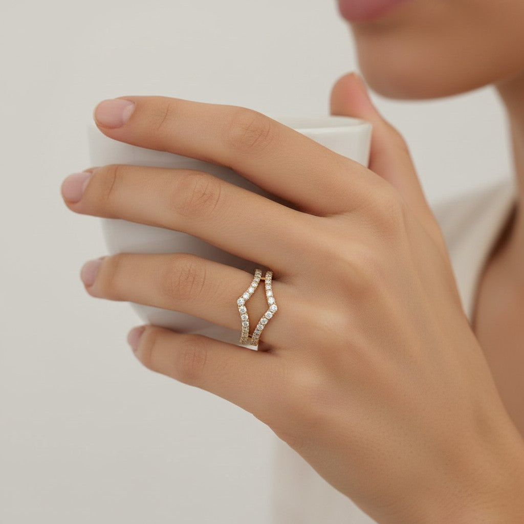My Store 4 double chevron ring enhancer in 18k yellow gold with micro-pavé diamonds worn on a woman's finger