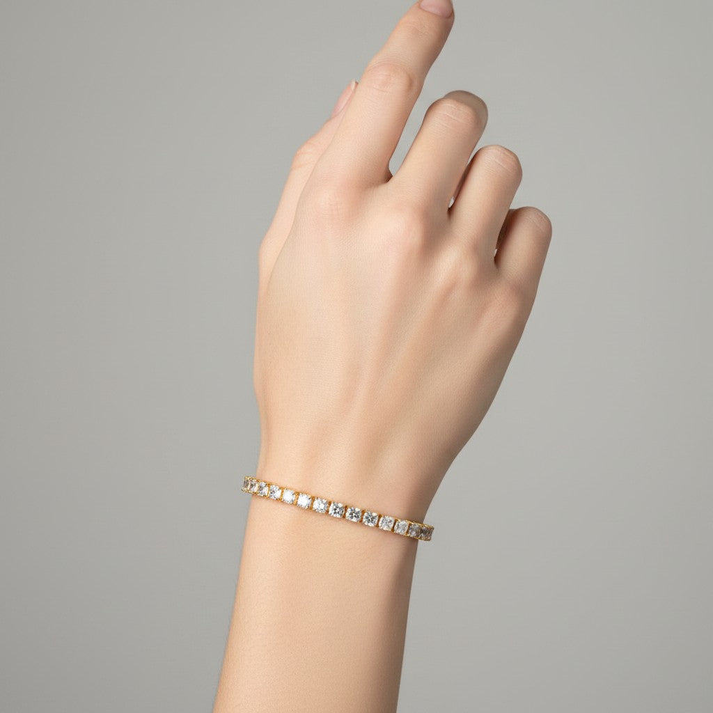 My Store 4 custom diamond tennis bracelet in yellow gold worn on a woman's wrist against a neutral background.