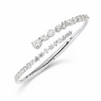 My Store 4 contemporary white gold bypass bangle featuring round, marquise, and pear-cut diamonds in a double-row design.