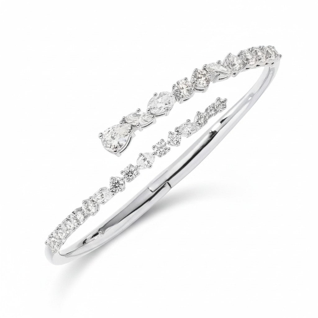 My Store 4 contemporary white gold bypass bangle featuring round, marquise, and pear-cut diamonds in a double-row design.
