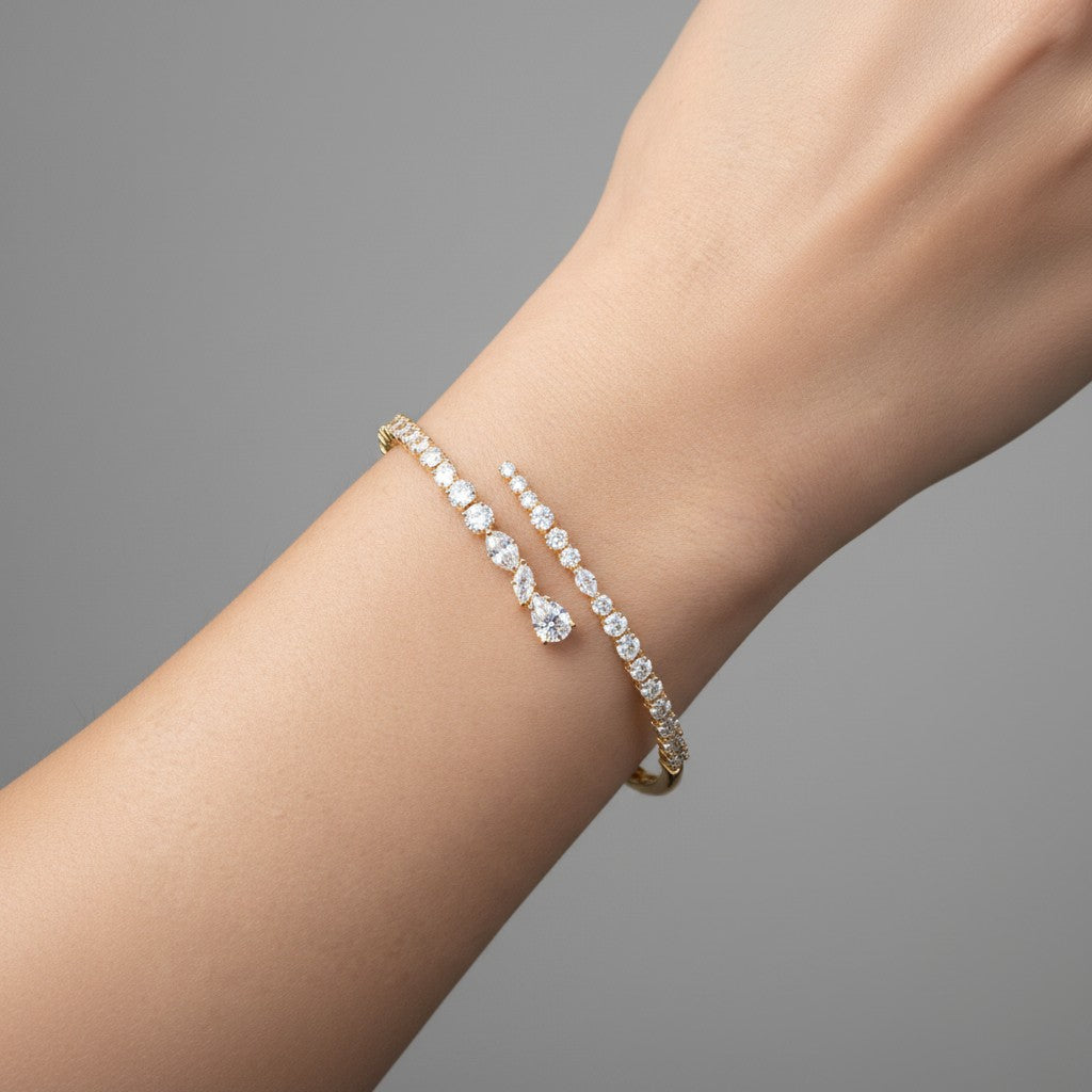 My Store 4 contemporary gold bypass bangle featuring mixed round, marquise, and pear-cut diamonds on a wrist.