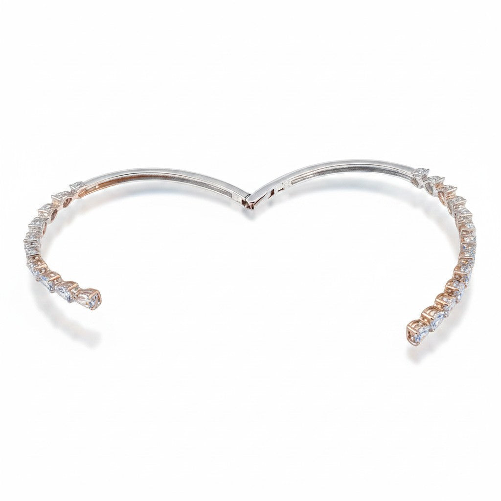 My Store 4 open bypass bangle bracelet featuring alternating pear and heart cut diamonds set in polished gold.