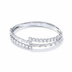 My Store 4 bypass open bangle bracelet featuring alternating baguette and round brilliant diamonds in white gold