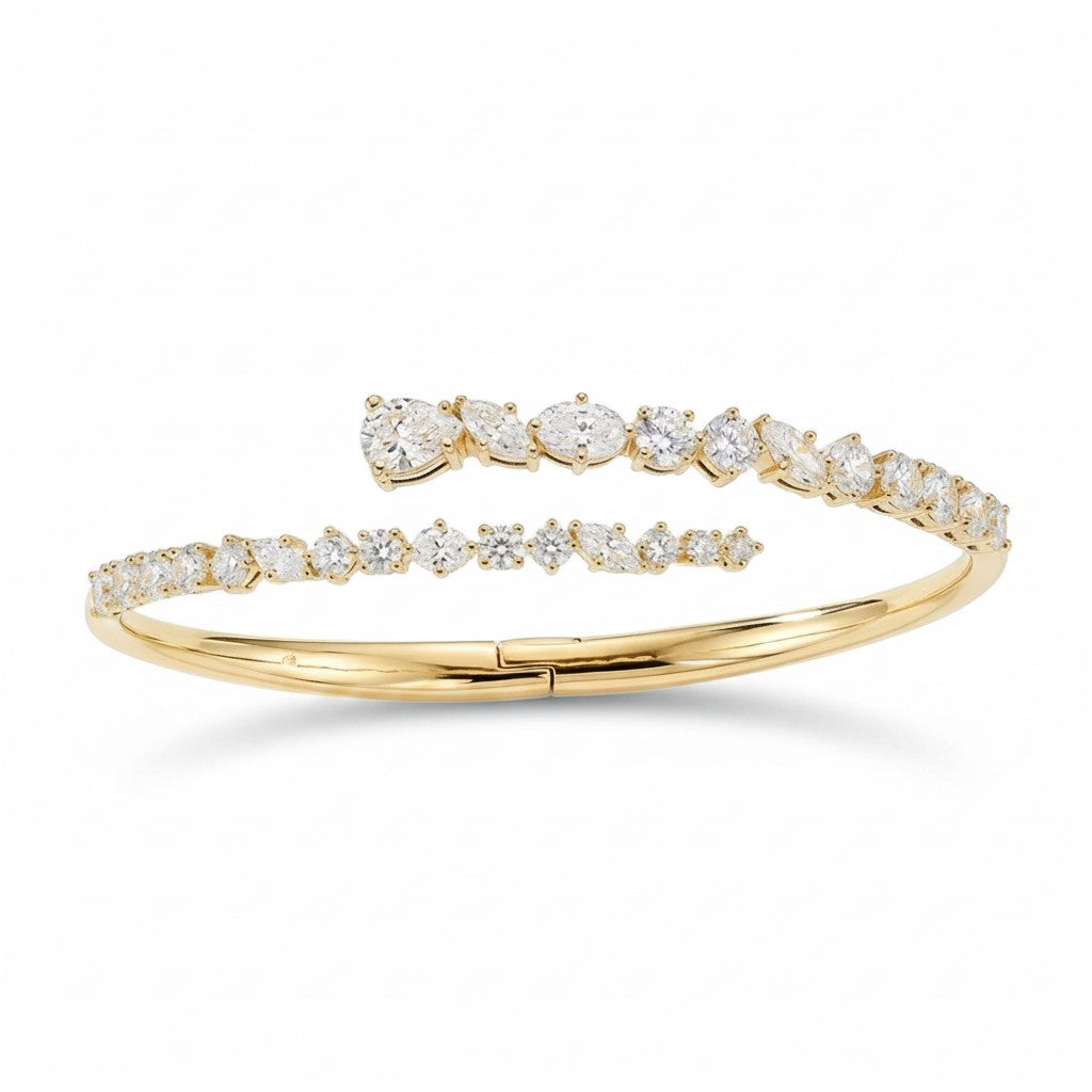 My Store 4 contemporary gold bypass bangle featuring round, marquise, and pear-cut diamonds in a hinged open design.