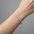 My Store 4 contemporary bypass bangle featuring mixed-cut diamonds in a rose gold setting worn on a wrist.