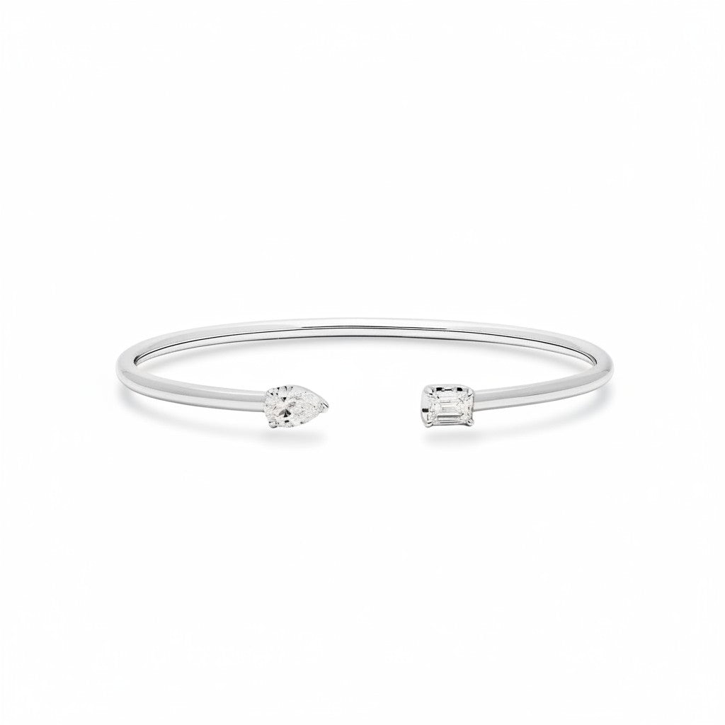 My Store 4 open cuff bracelet in white gold with a pear-cut and an emerald-cut diamond on a minimalist band.