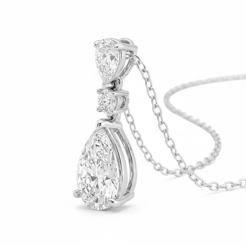 My Store 4 three-stone diamond drop pendant necklace in 18K white gold with pear and round cut stones.