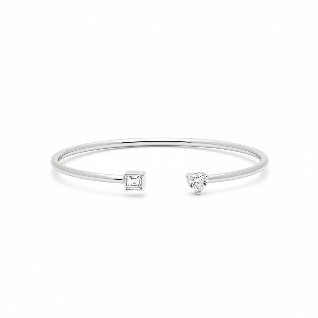 My Store 4 open cuff bracelet in white gold with a pear-cut and emerald-cut diamond in a minimalist prong setting.