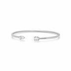 My Store 4 open cuff bracelet in white gold featuring an asymmetrical pear-cut and emerald-cut diamond solitaire.