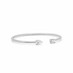 My Store 4 open cuff bracelet in white gold with a pear-cut diamond on one end and an emerald-cut diamond on the other.