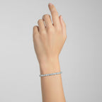 My Store 4 custom 4-prong diamond tennis bracelet in white gold worn on a woman's wrist