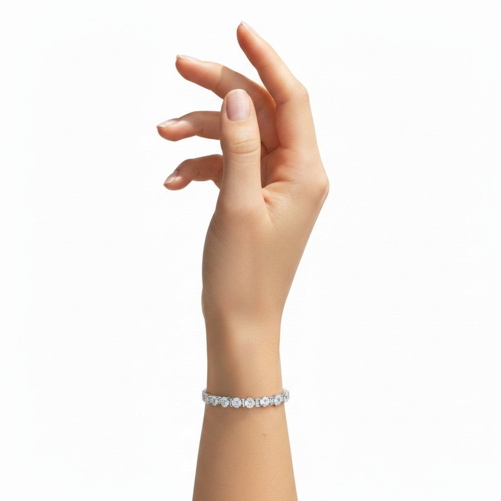 My Store 4 custom diamond tennis bracelet with round and emerald cut stones in a gold setting on a woman's wrist.