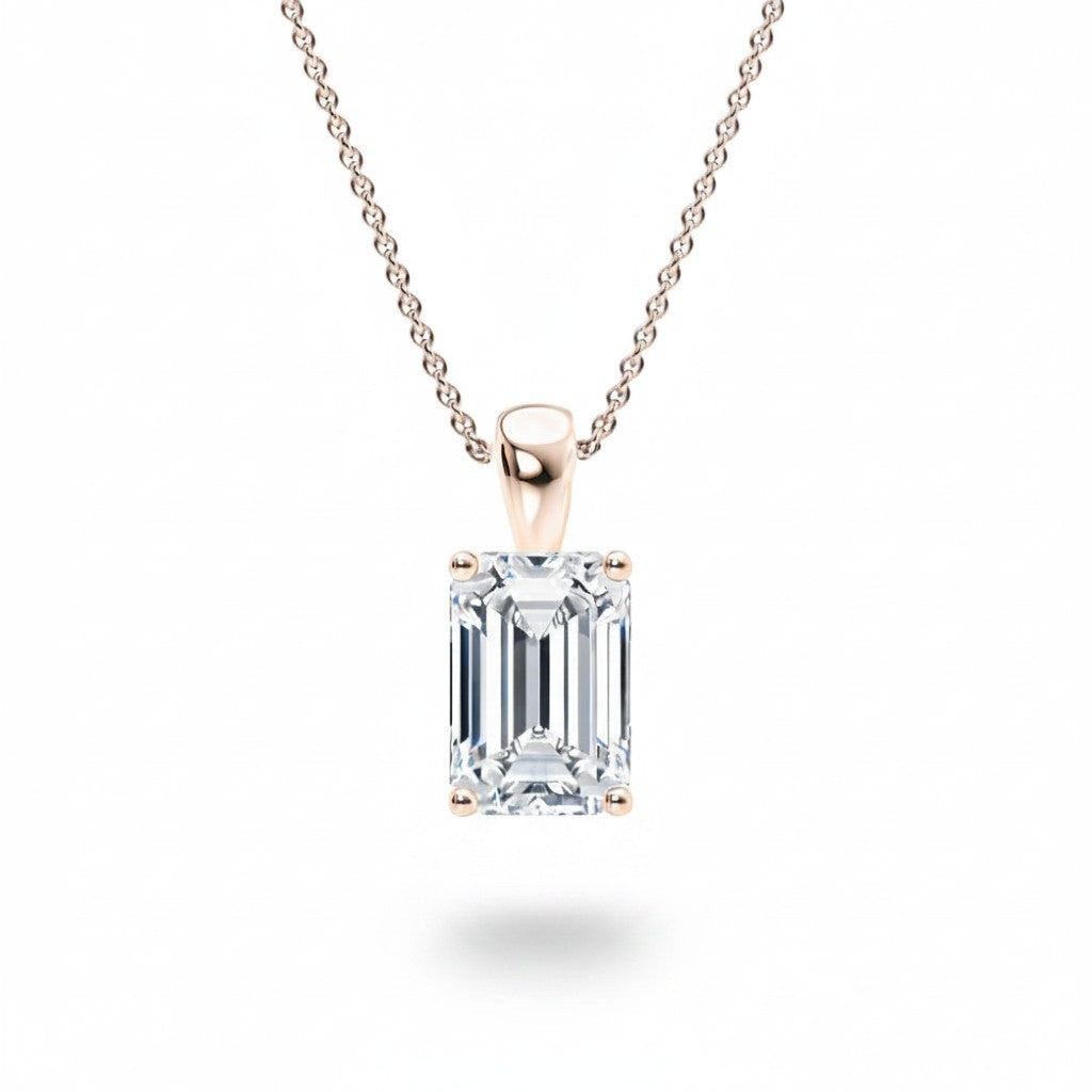 My Store 4 emerald-cut diamond solitaire pendant in 18K yellow gold with a tapered bail on a fine cable chain.