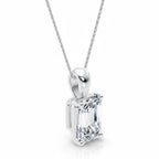 My Store 4 emerald-cut diamond solitaire pendant in white gold on a delicate cable chain, featuring a tapered bail.