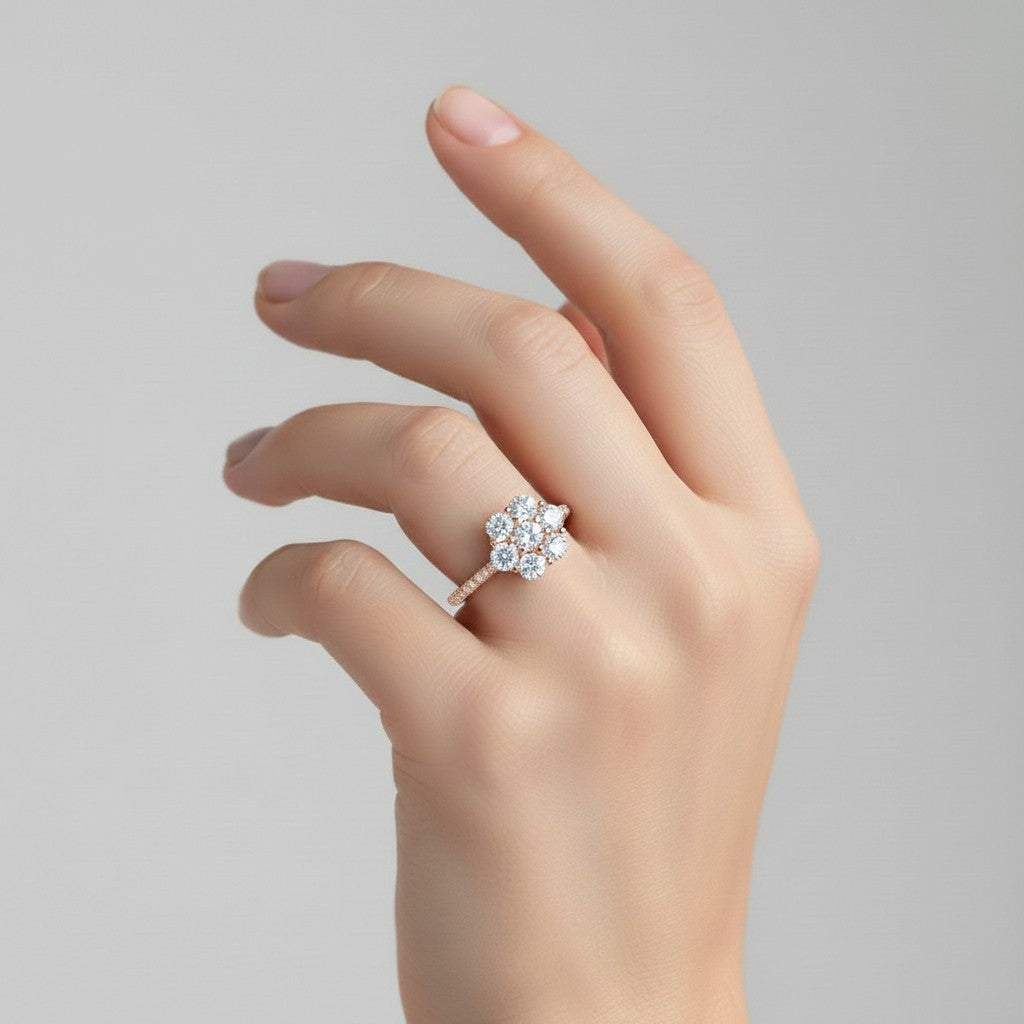 My Store 4 seven-stone floral cluster engagement ring with round brilliant diamonds on a pavé solid gold band on a hand.