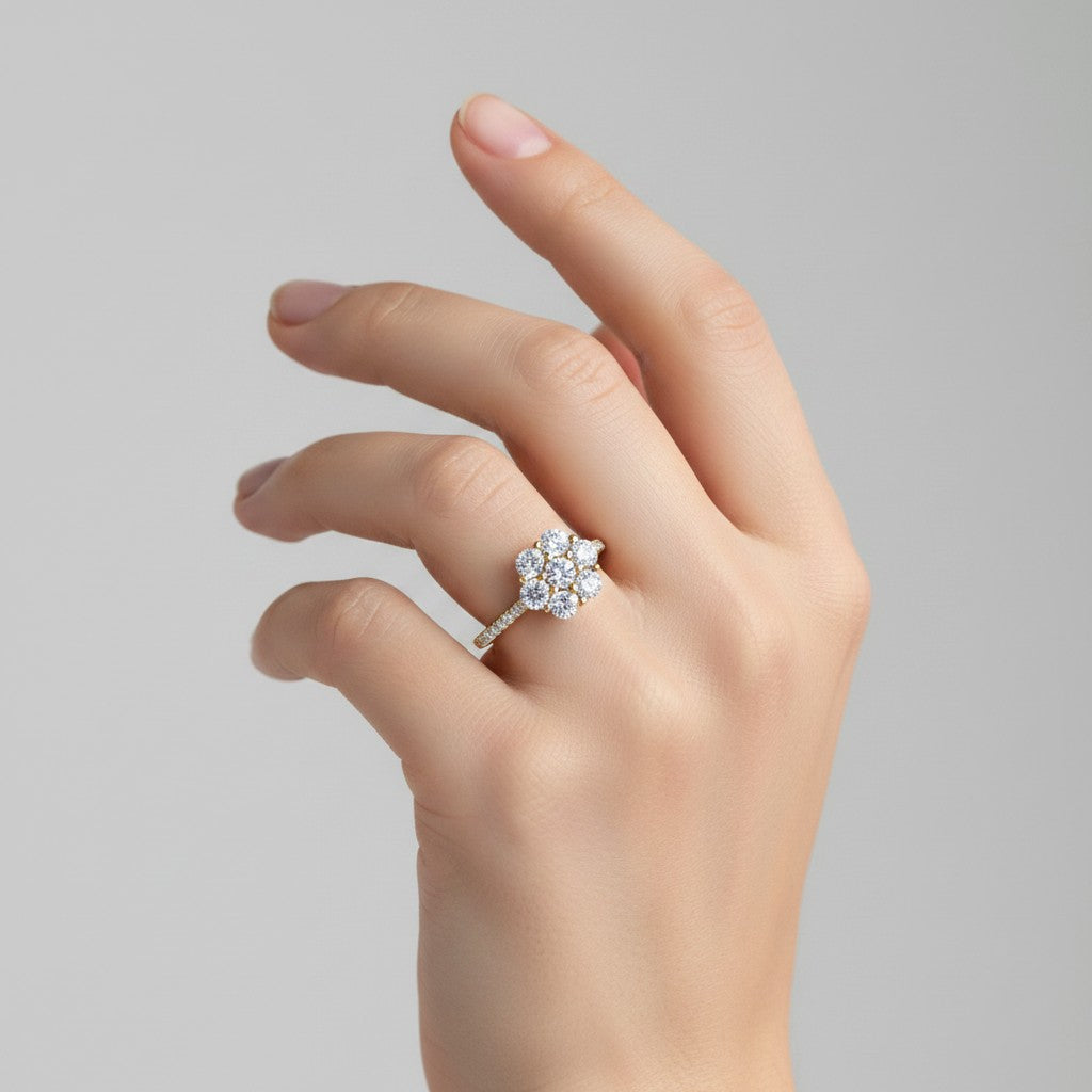My Store 4 seven-stone floral cluster engagement ring with a micro-pavé diamond band on a woman's finger in yellow gold.