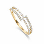 My Store 4 bypass open bangle bracelet in yellow gold featuring alternating baguette and round brilliant diamonds.