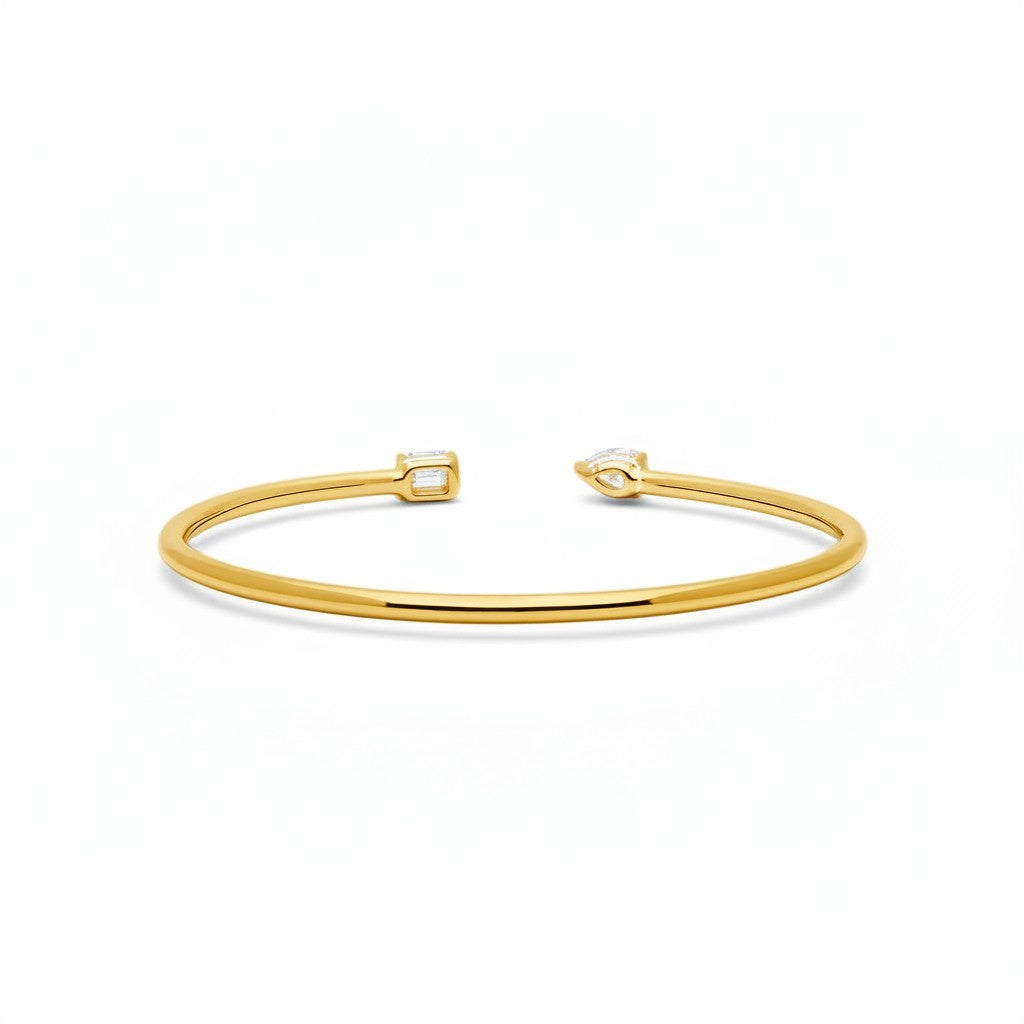 My Store 4 open cuff bracelet in yellow gold with an asymmetrical pear-cut and emerald-cut diamond focal point.