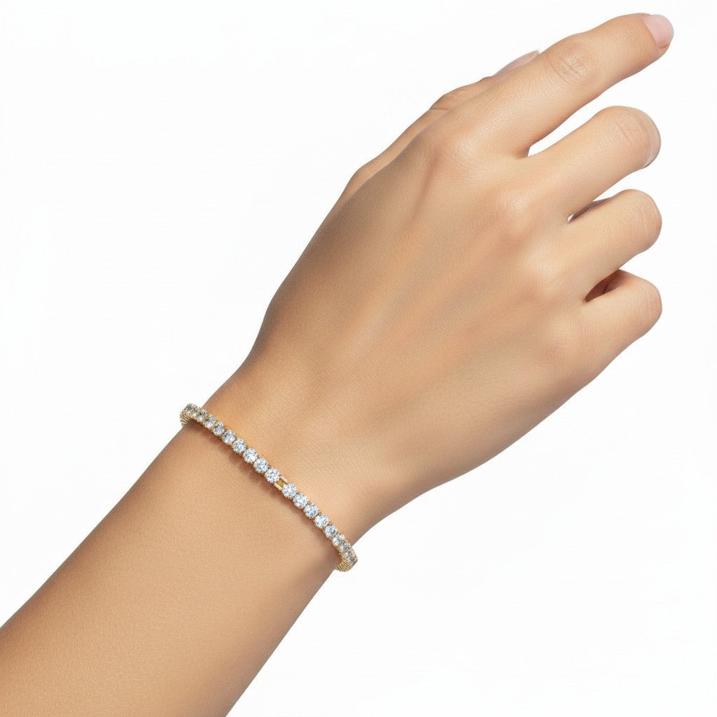My Store 4 round diamond tennis bracelet in yellow gold with a four-prong setting worn on a woman's wrist.