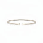 My Store 4 minimalist open cuff bracelet in polished gold with a sleek, tapered design on a white background.
