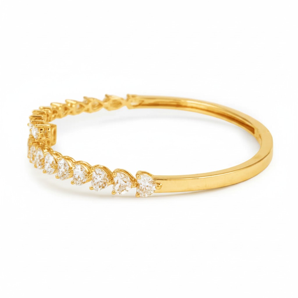 My Store 4 gold open bangle bracelet featuring alternating pear and heart cut diamonds in a bypass silhouette.