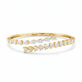 My Store 4 yellow gold bypass open bangle bracelet featuring alternating pear-cut and heart-cut diamond stones.