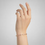 My Store 4 graduated diamond open cuff bracelet in rose gold worn on a woman's wrist