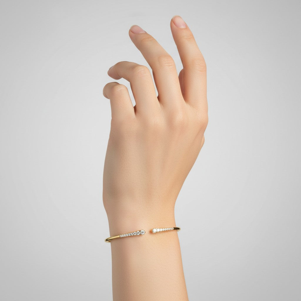 My Store 4 graduated diamond open cuff bracelet in yellow gold worn on a woman's wrist