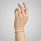 My Store 4 graduated diamond open cuff bracelet in yellow gold worn on a woman's wrist