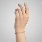 My Store 4 graduated diamond open cuff bracelet in polished white gold worn on a woman's wrist