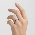 My Store 4 heart-cut diamond engagement ring and matching micro-pavé wedding band set worn on a woman's finger.