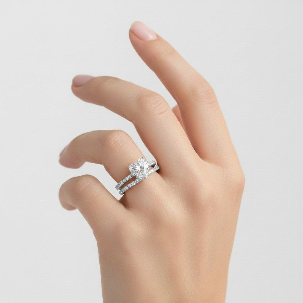 My Store 4 heart-cut diamond engagement ring and matching micro-pavé wedding band set worn on a woman's finger.