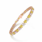 My Store 4 tennis bracelet featuring alternating fancy yellow and white heart-cut diamonds in a two-tone gold setting.