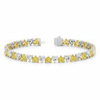 My Store 4 two-tone tennis bracelet featuring alternating fancy yellow and white heart-cut diamonds in gold settings.