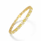 My Store 4 tennis bracelet featuring alternating fancy yellow and white heart-cut diamonds in two-tone gold settings.