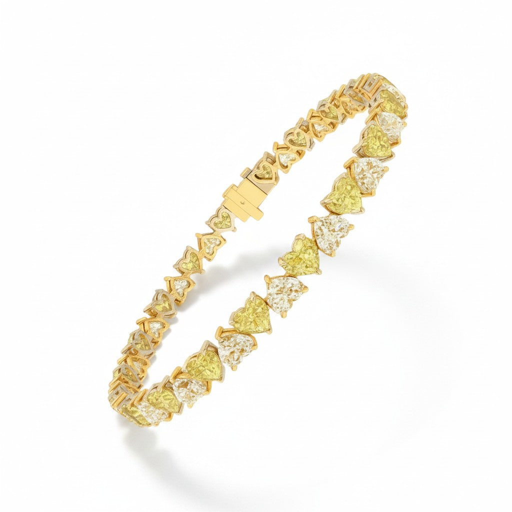 My Store 4 tennis bracelet featuring alternating fancy yellow and white heart-cut diamonds in two-tone gold settings.
