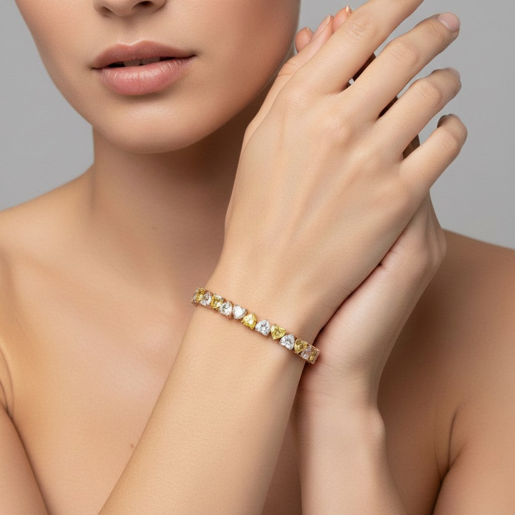 My Store 4 tennis bracelet featuring alternating fancy yellow and white heart-cut diamonds in two-tone gold settings.