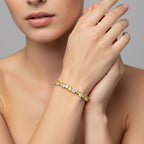 My Store 4 two-tone tennis bracelet featuring alternating fancy yellow and white heart-cut diamonds on a model's wrist.