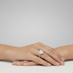 My Store 4 18K solid gold solitaire ring with a heart-shaped lab-grown diamond and pavé band on a woman's hand.