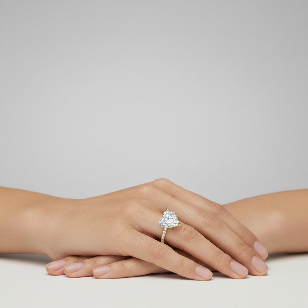 My Store 4 18K solid gold solitaire ring with a heart-shaped lab-grown diamond and pavé band worn on a hand