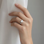 My Store 4 18K solid gold solitaire diamond ring with a heart-shaped stone worn on a woman's hand against fabric.