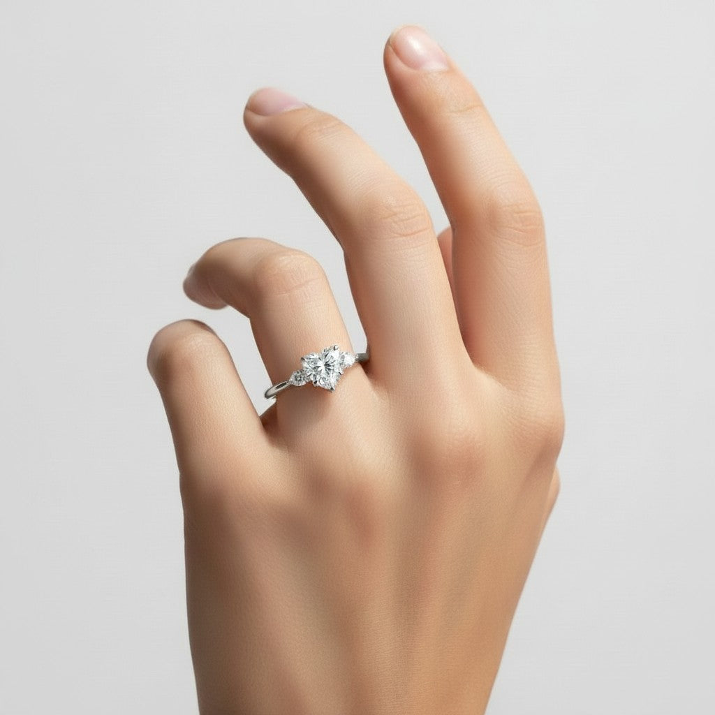 My Store 4 18K solid gold trilogy engagement ring featuring a heart-shaped lab-grown diamond on a woman's finger.
